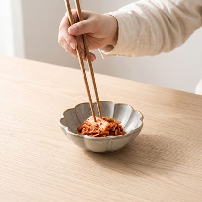 Petal glaze side dish with kimchi on a pale oak table