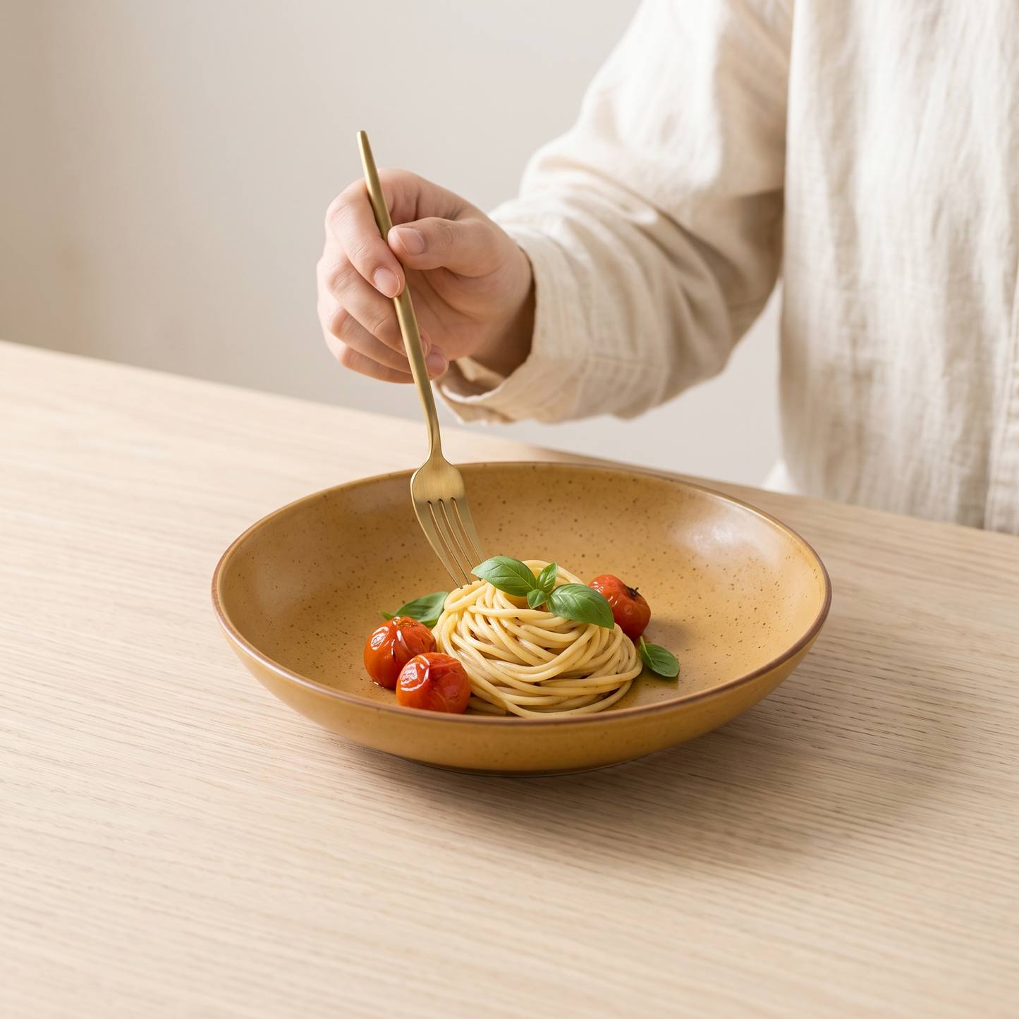 Amber retro colour-glaze deep plate with pasta on a pale oak table