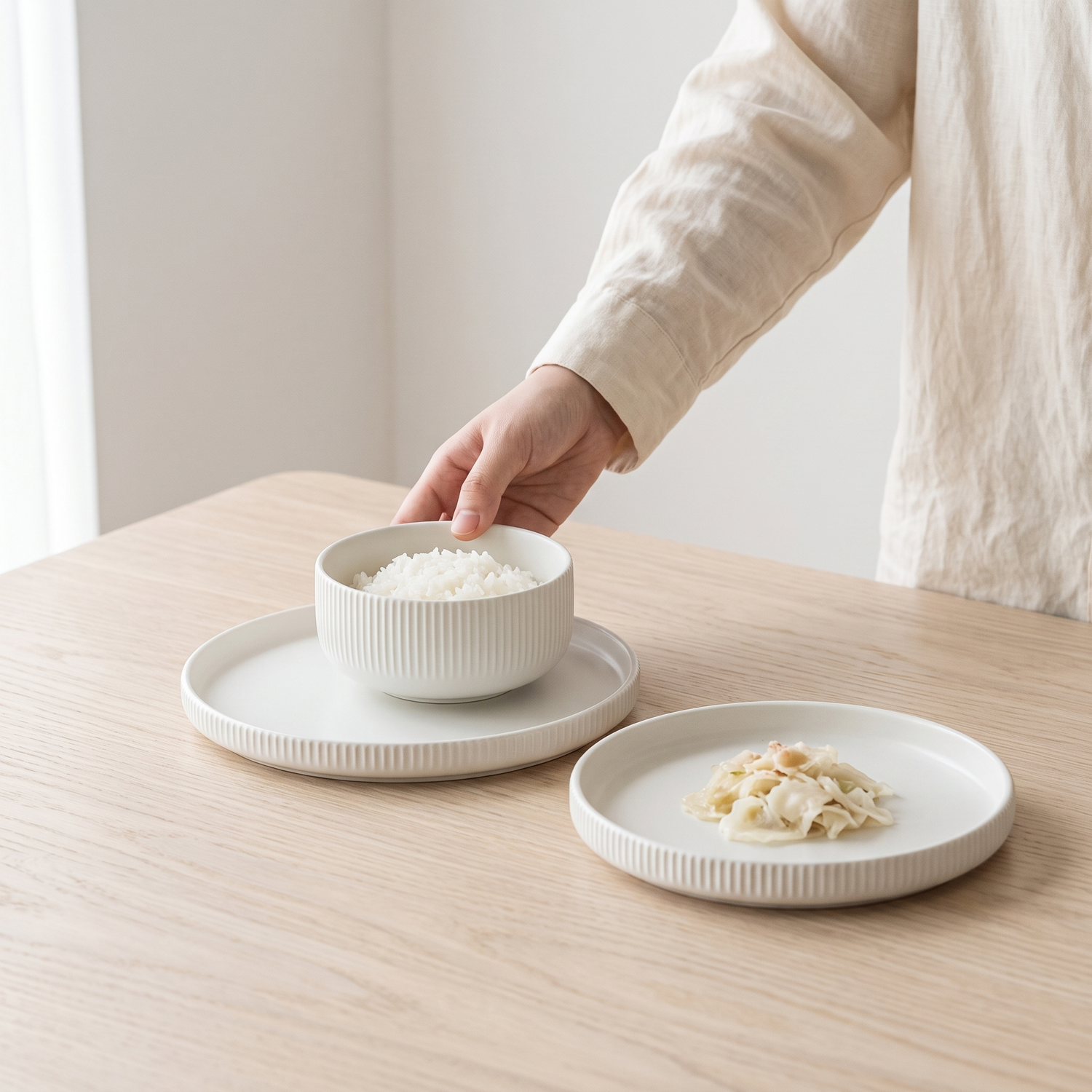 Monochrome Japanese dinnerware on a pale oak table