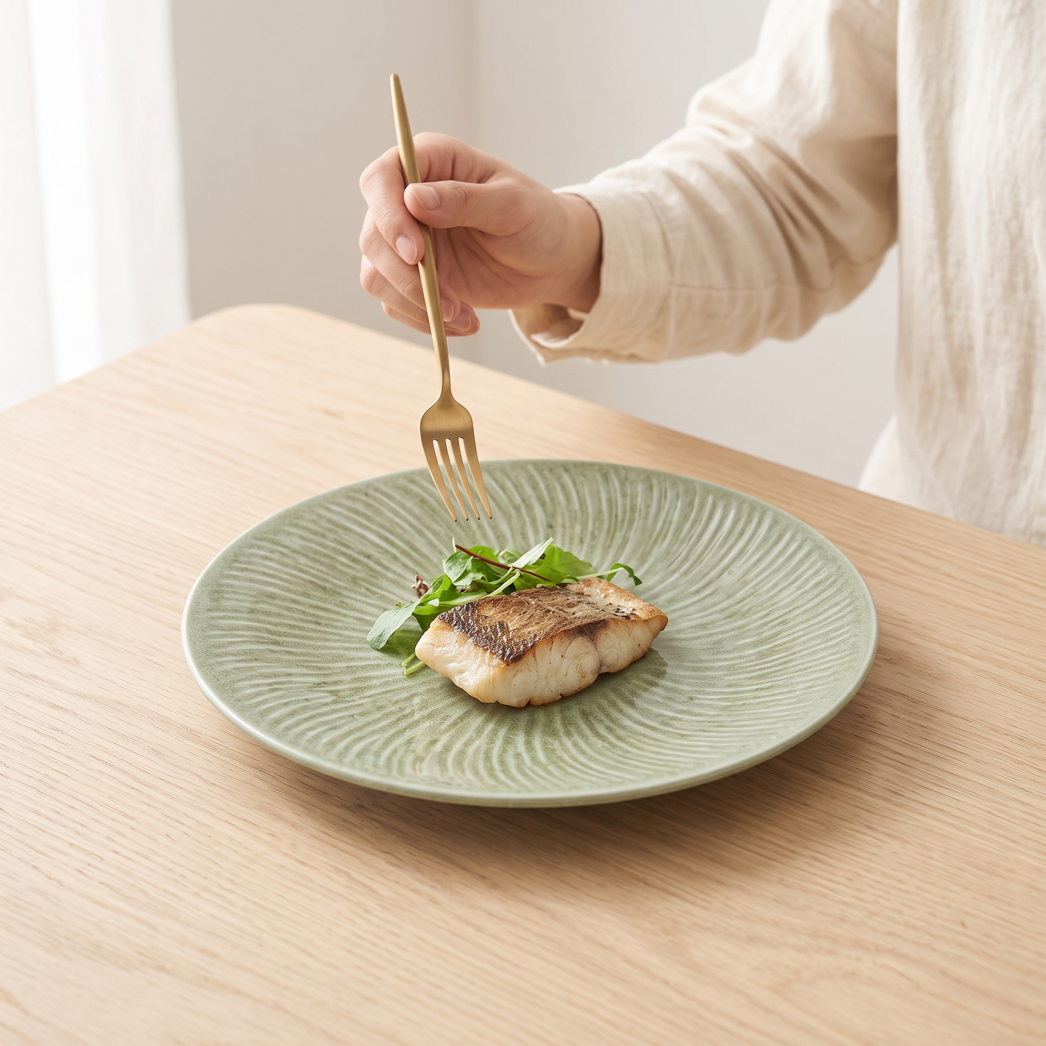 Yohen kiln-transformation ceramic plate with seared fish on a pale oak table
